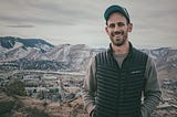 Cameron Naish standing in front of mountains in winter in Golden, Colorado.