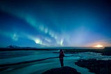 Person taking in outdoor view at night