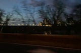 A blurred image of a bridge over the Potomac river at seven in the morning.