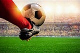 a foot kicking soccor ball