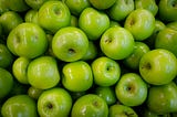 A lot of shiny green apples.