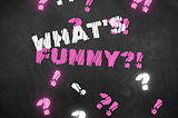 The What’s Funny?! logo. It’s Just letters with a smidge of silliness blended with statement-making. Pink-and-white whimsy on black chalkboard.