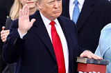 An image of President Donald Trump being sworn into office with his hand on two bibles.