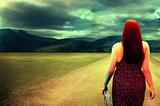 Curvy woman with long red hair walking on a light path into the unknown