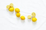 Lemons, whole and cut, on a white background.