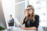 Portrait of a young businesswoman using a digital tablet at her desk in a modern office