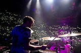 Drummer Tim Oxford drumming on stage at an Arkells concert