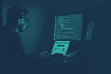 developer writing code in a dark room