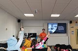 Voluneers delivering an aeronautical engineering session in a classroom