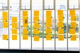 Unconference board with participant-suggested sessions on yellow sticky notes.