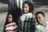 Three Black children are pictured with an adult.