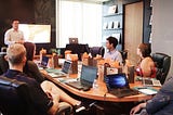 group of people having a meeting in a conference room
