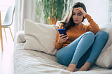 Frustrated upset women looking at her phone
