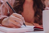 A woman writes with her pencil