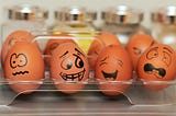 Marketing psychology image showing 8 eggs with face drawn on them.