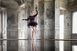 Woman poses as a ballerina for the professional portrait photographer Damien Lovegrove, client of RYDE.