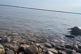 picture of a lake and lakefront with pebbles on it