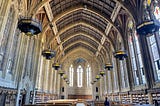 A large library hall in a gothic style architecture.