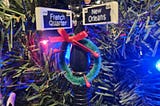Christmas decoration of an old fashioned light post, with French Quarter and New Orleans written on the signs.