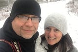 A gen-x couple taking a selfie outside on a winters day.