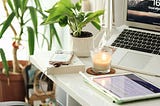 https://www.pexels.com/photo/work-space-with-candle-and-charging-phone-on-desk-10801695/