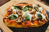 Pinsa on a pizza peel