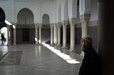 The Spiritual Journey of the Believer: A old man standing in a mosque