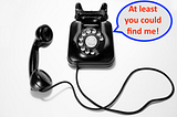 An old-fashioned, rotary dial phone rests on a grey background. Its speech bubble reads: “At least you could find me!”