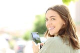 student with phone, smiling