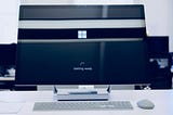 A monitor displays the load screen logo of windows 10.