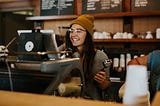 Happy girl working in a coffee shop.