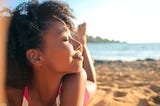 Woman basking in the sun on the beach