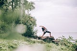 Photograph of a woman practicing yoga outdoors
