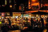 People eating street food at Ningxia Night Market in Taiwan