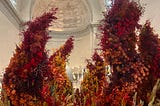 a 15 foot tall flower bouquet in the legion of honor’s main corridor.