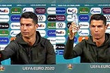Cristiano Ronaldo swaps coke with water during a press conference