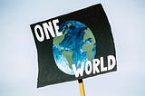 Protest sign saying ‘One world’