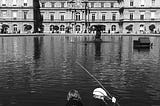 Kids (a boy and a girl) racing with miniature boats on the lake in Jardin du Luxembourg. Paris, 2019