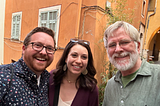 My wife and I posing with travel author Rick Steves in a street in France