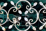 Wrought Iron Fleur-de-lis on a saturated, green background