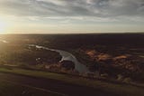 Sunset overlooking a river within a canyon.