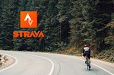 Biker riding down a road, Strava logo on the back.