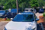 a honda parked in a spot reserved for clergy only at a hospital emergency room entrance.