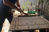 Eric using a Japanese hand saw on his workbench
