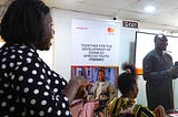 An interpreter and a facilitator addressing the class during a soft skill training