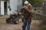 Joe Exotic pointing his gun at the camera