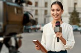A journalist talking to a camera.