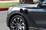 A 2020 Lincoln Aviator Grand Touring is plugged in and charging.