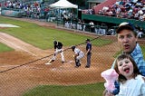 Photo of an at bat but superimposed on the side is my kid and her uncle both have a very good time in 2003.