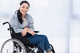 A disabled woman sitting on a wheelchair while wearing a headphone